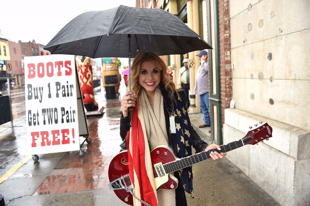 Lindsay Ell Busking on Broadway in the rain. Photo Credit John Shearer